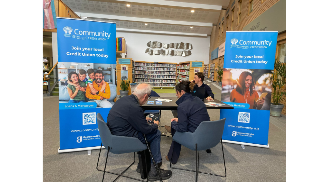 People sit at a table between two 